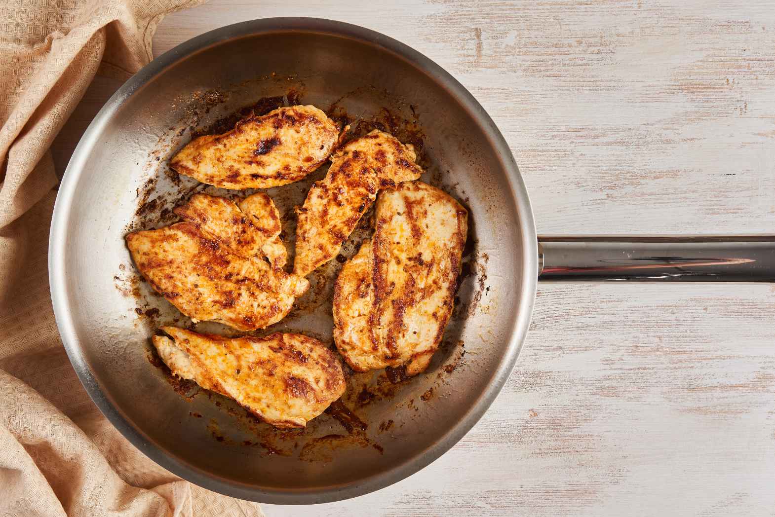 Stainless steel pan with cooked chicken